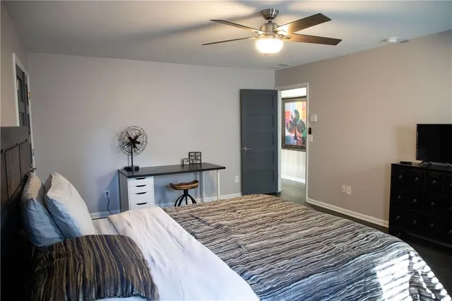 a bedroom with a bed and a television