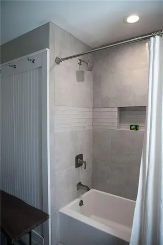 a bathroom with a bathtub and a shower