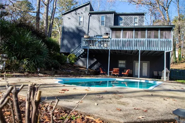 a view of a house with a yard and sitting area