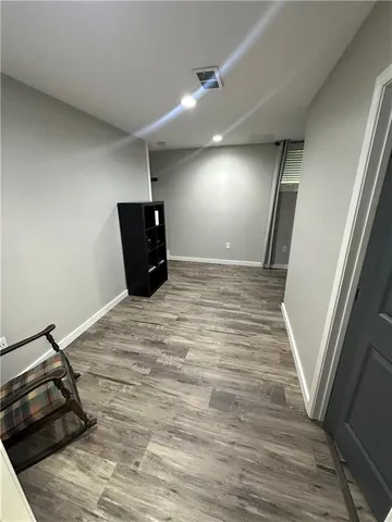 a view of a room with wooden floor