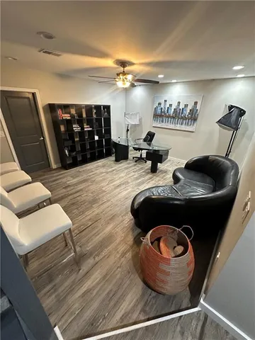 a kitchen with a wooden floor and a potted plant