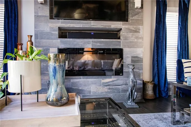 a living room with a fireplace and a flat screen tv