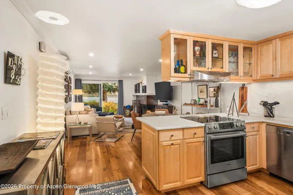 a kitchen with a stove a sink a refrigerator and cabinets