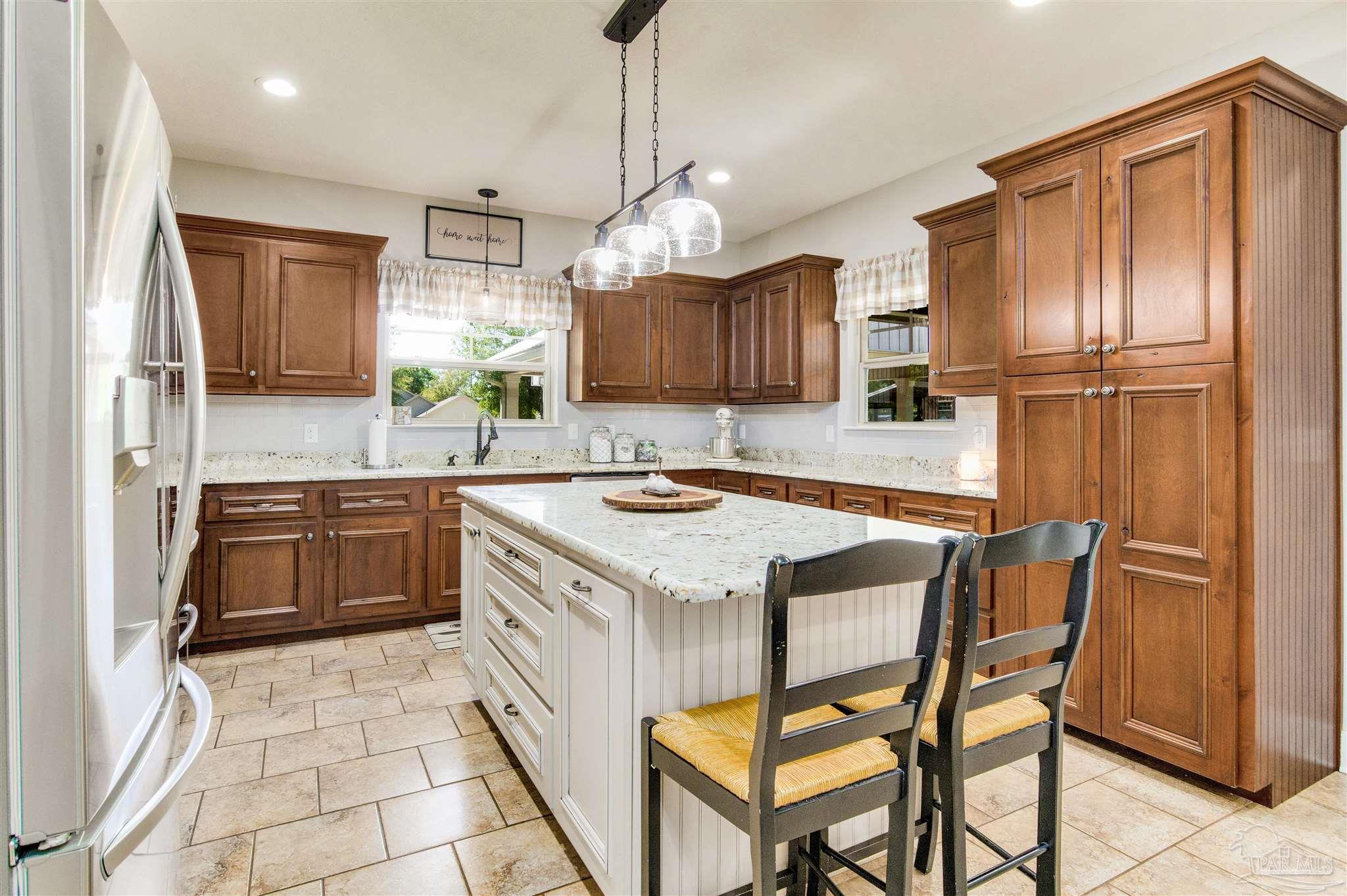 7223 Martin Road Milton, FL 32570 - Photo 14 of 27 a kitchen with stainless steel appliances granite countertop a sink stove and refrigerator