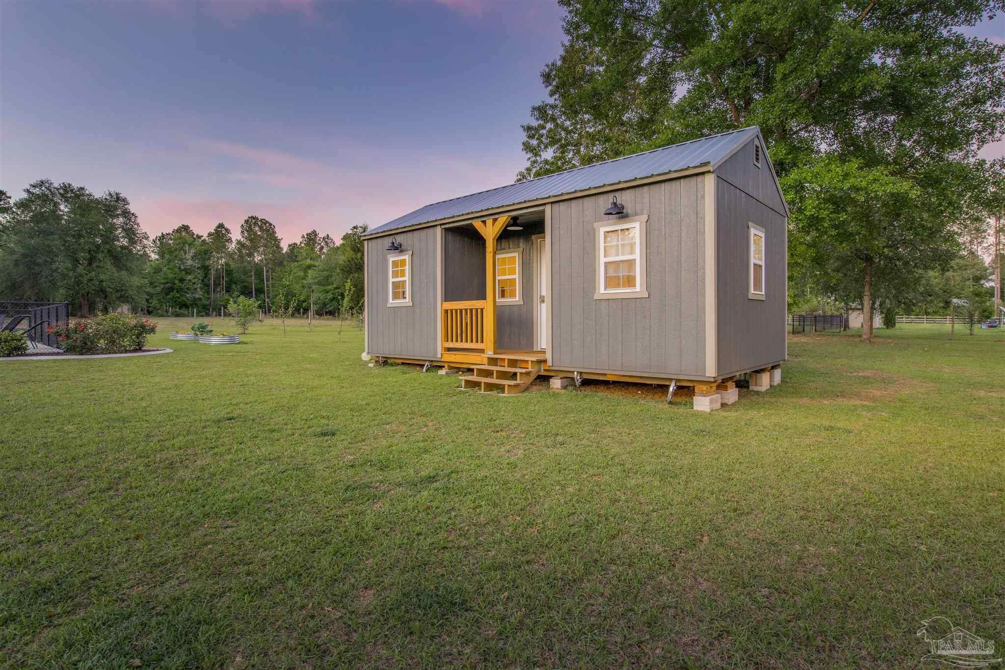 7223 Martin Road Milton, FL 32570 - Photo 17 of 27 a front view of a house with garden