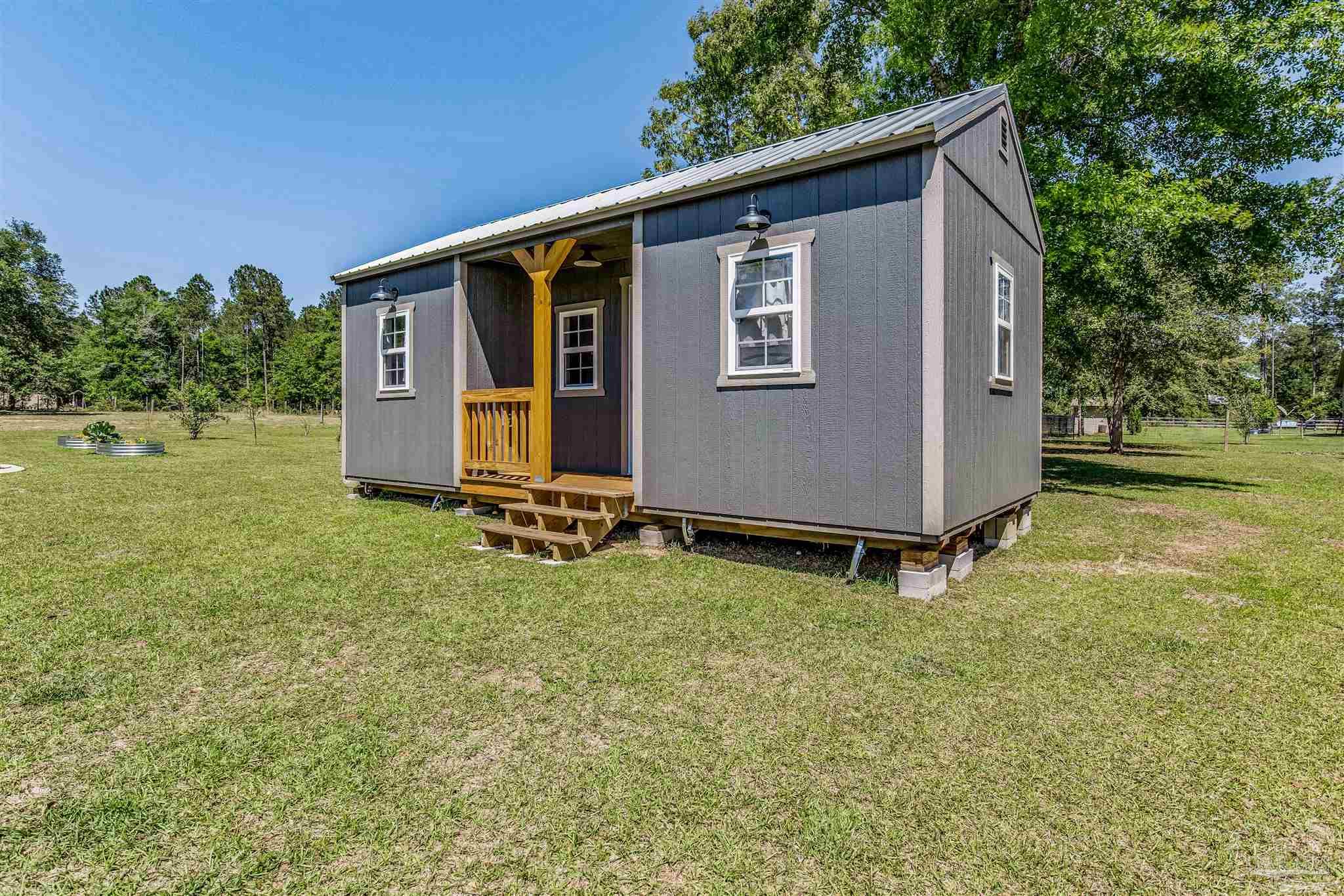 7223 Martin Road Milton, FL 32570 - Photo 18 of 27 a backyard of a house with lots of green space