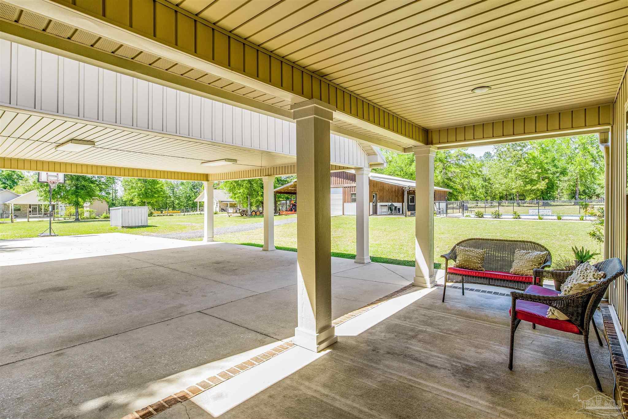 7223 Martin Road Milton, FL 32570 - Photo 19 of 27 a balcony with furniture and a garden