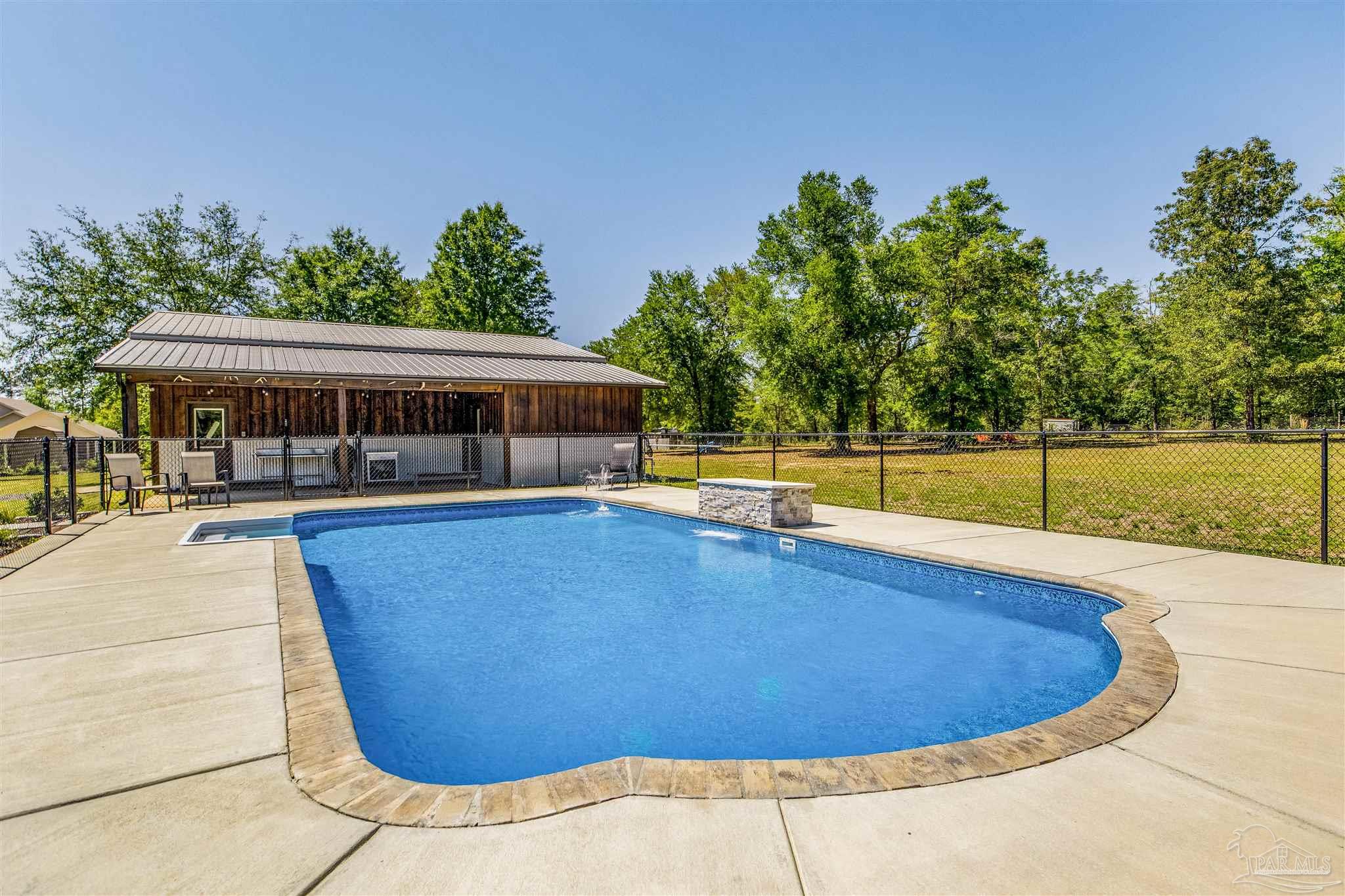 7223 Martin Road Milton, FL 32570 - Photo 20 of 27 a view of a swimming pool with an outdoor seating