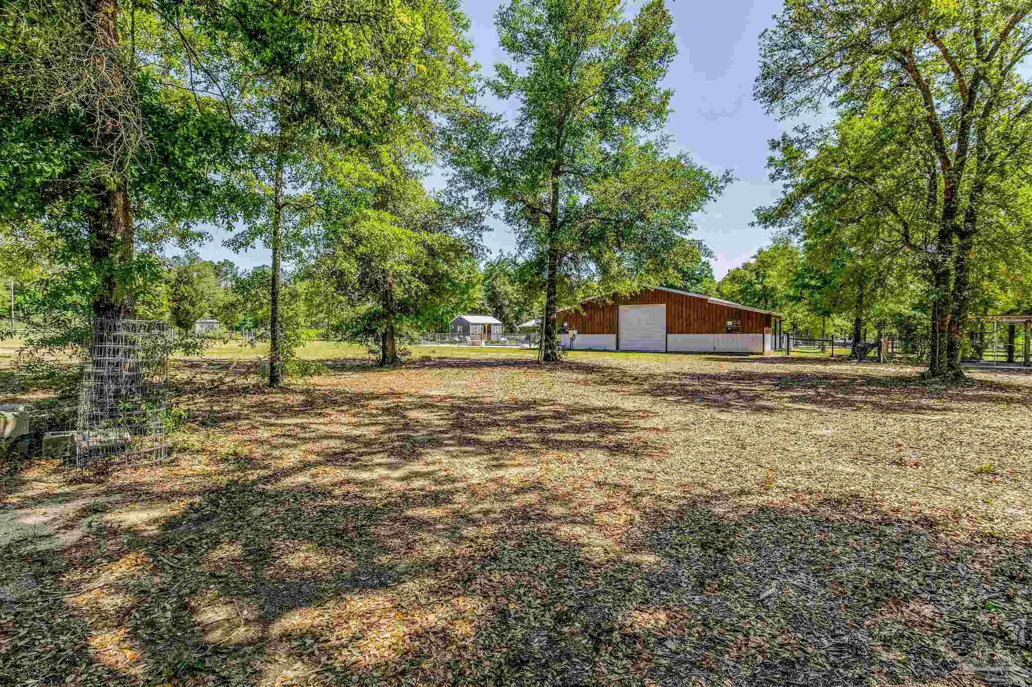 7223 Martin Road Milton, FL 32570 - Photo 25 of 27 a house with lots of trees