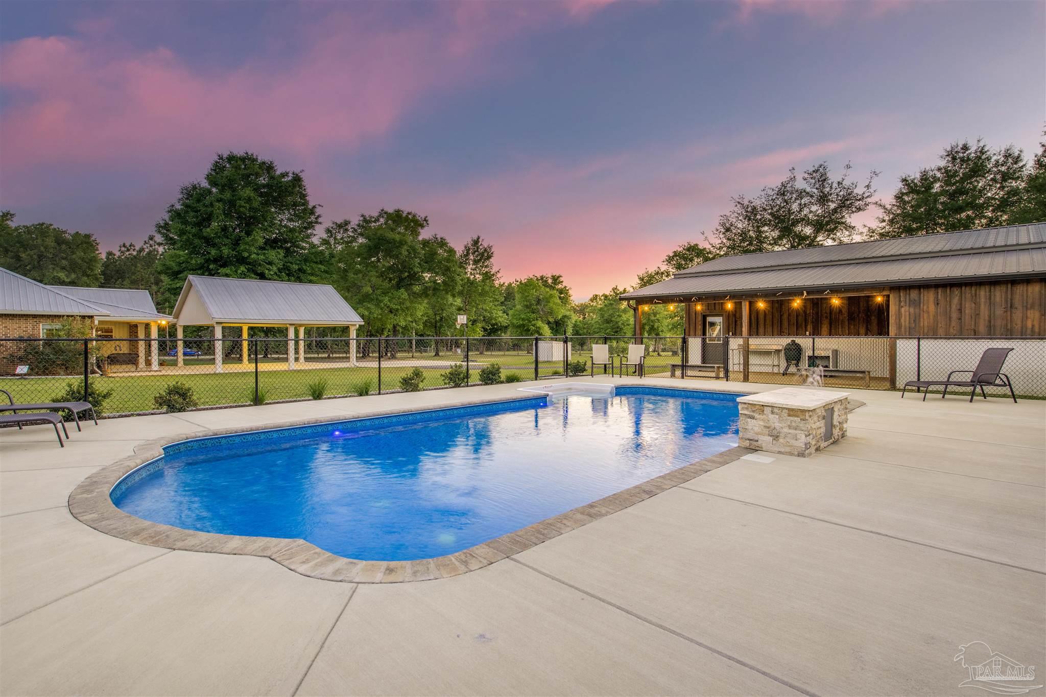 7223 Martin Road Milton, FL 32570 - Photo 8 of 27 a view of a swimming pool with an outdoor seating