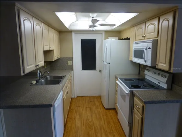 a kitchen with stainless steel appliances a sink stove and cabinets