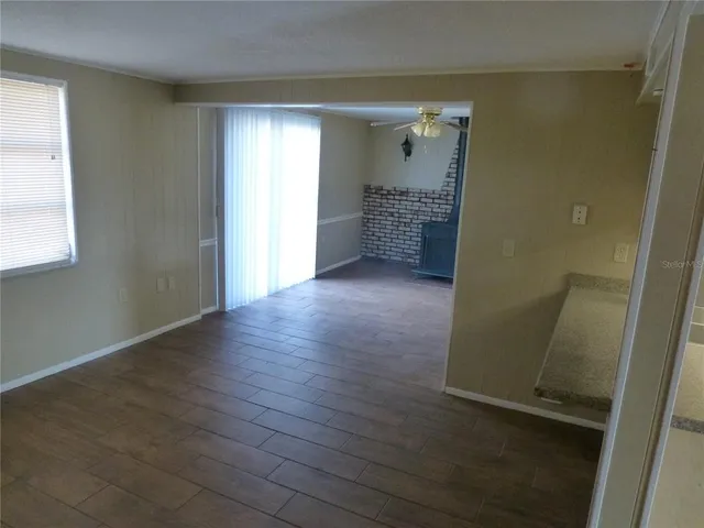 an empty room with wooden floor and closet
