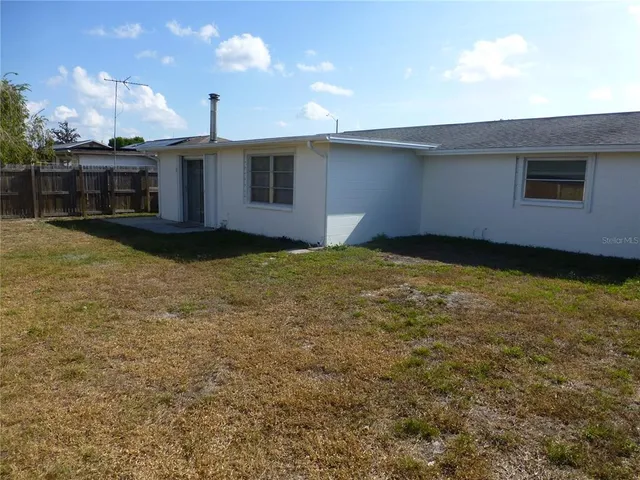 a view of a house with a backyard