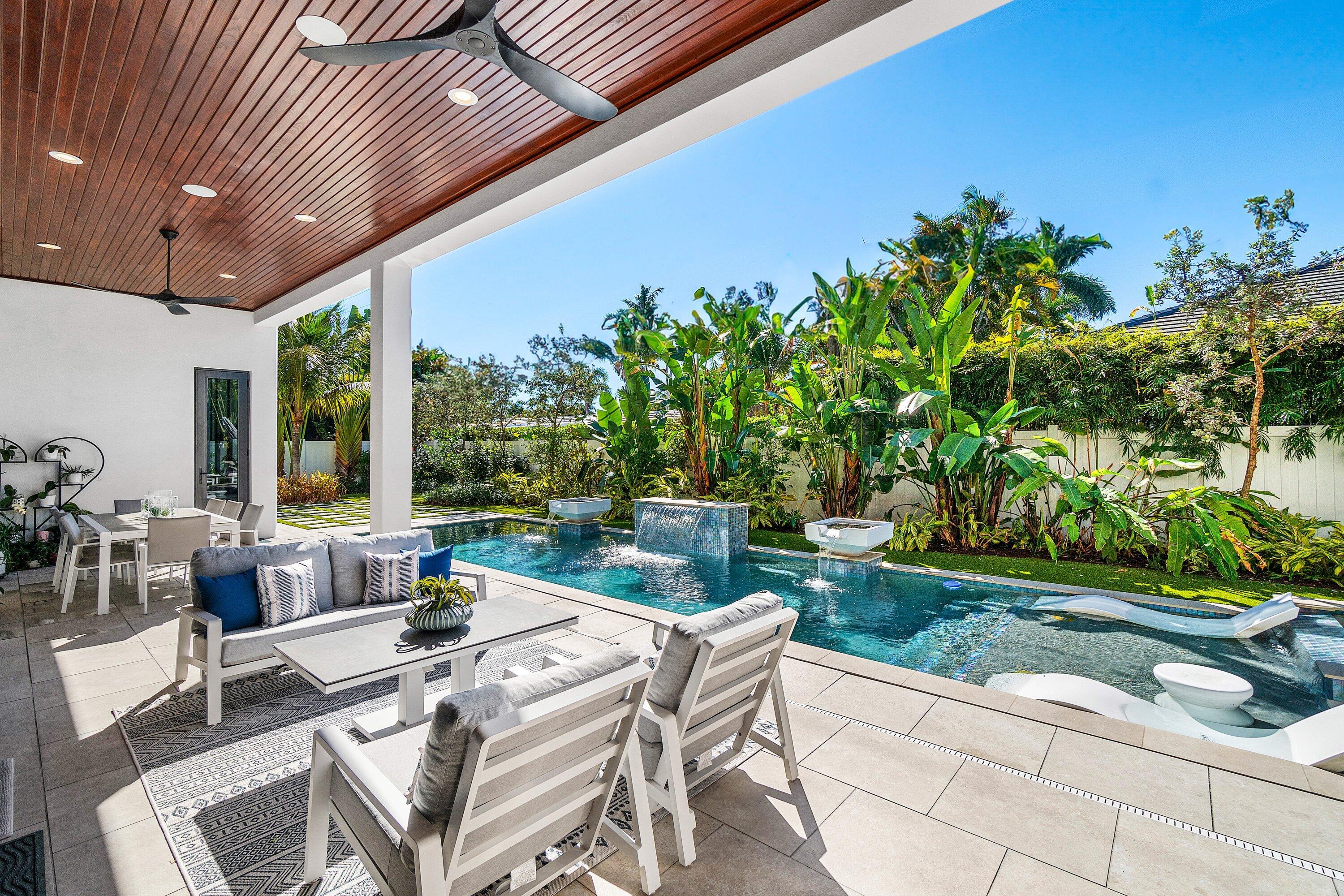 450 Northeast 10th Street Boca Raton, FL 33432 - Photo 116 of 119 a view of a patio with table and chairs potted plants and floor to ceiling window
