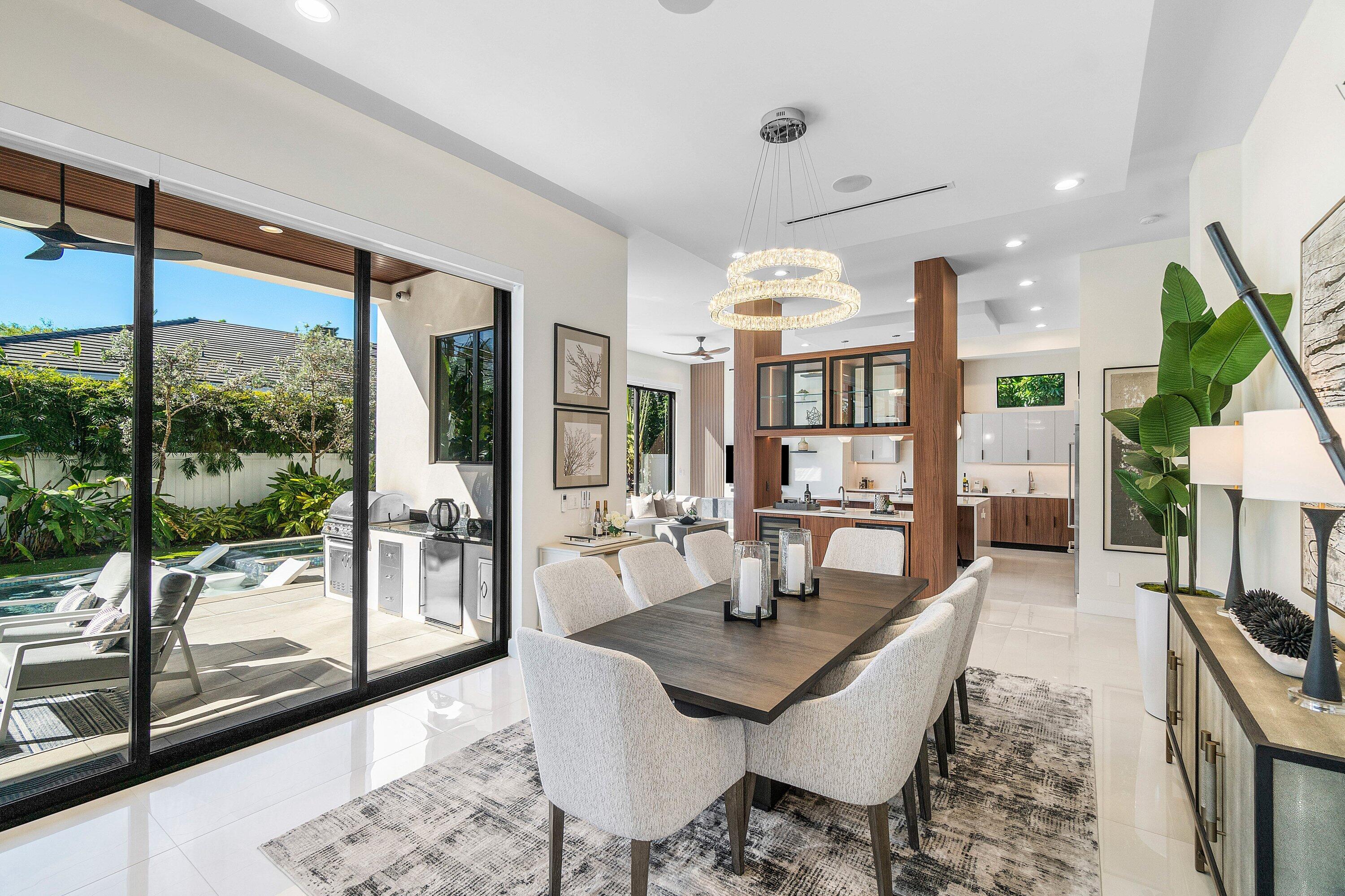 450 Northeast 10th Street Boca Raton, FL 33432 - Photo 19 of 119 a dining room with furniture a chandelier and wooden floor