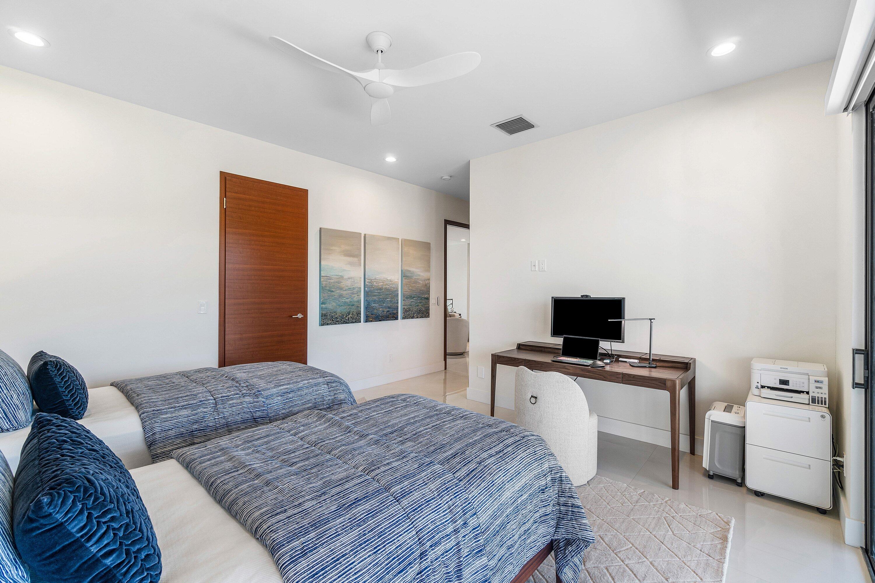 450 Northeast 10th Street Boca Raton, FL 33432 - Photo 39 of 119 a bedroom with a bed and a flat screen tv