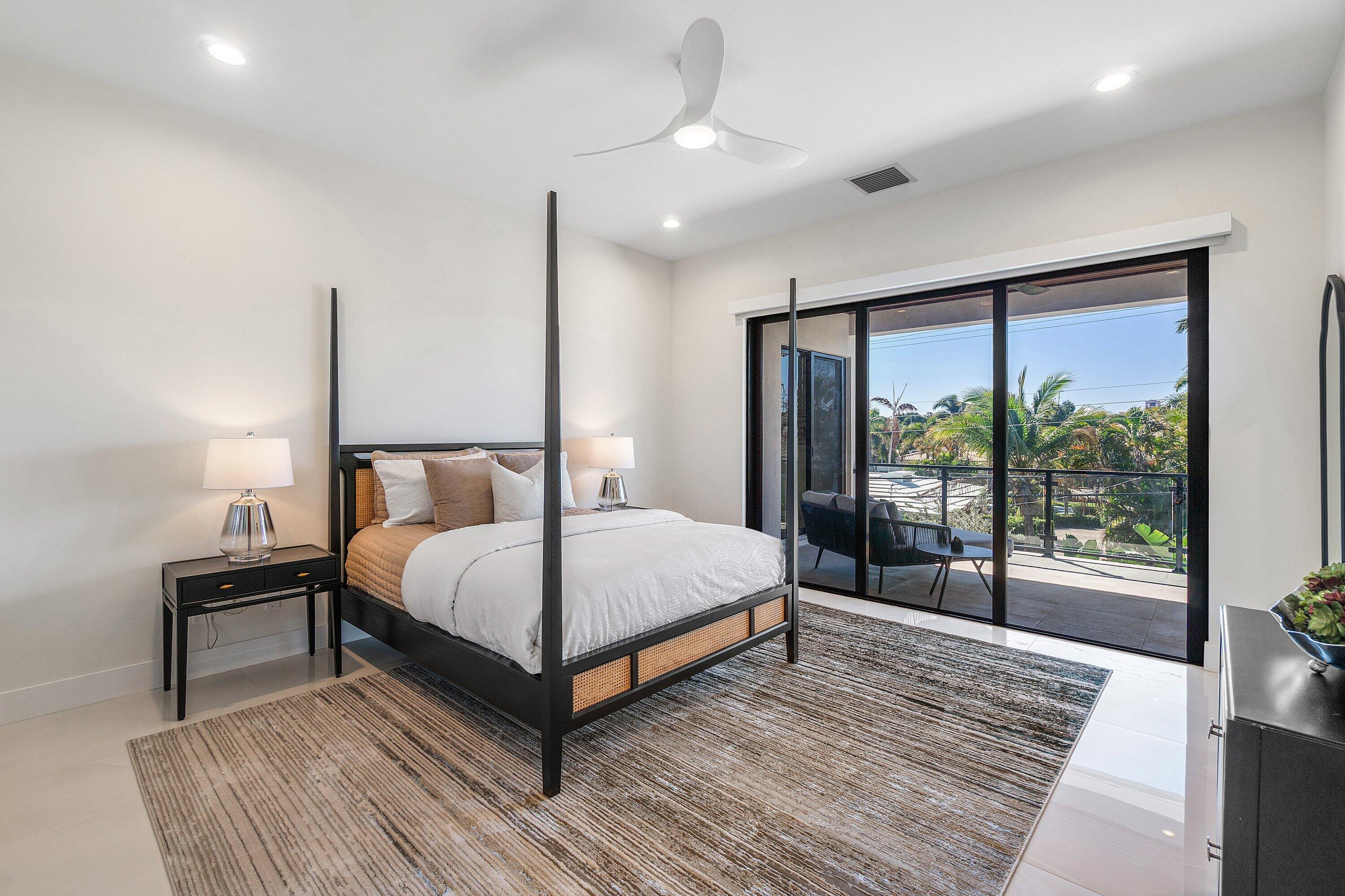 450 Northeast 10th Street Boca Raton, FL 33432 - Photo 41 of 119 a bedroom with a large bed and a large window