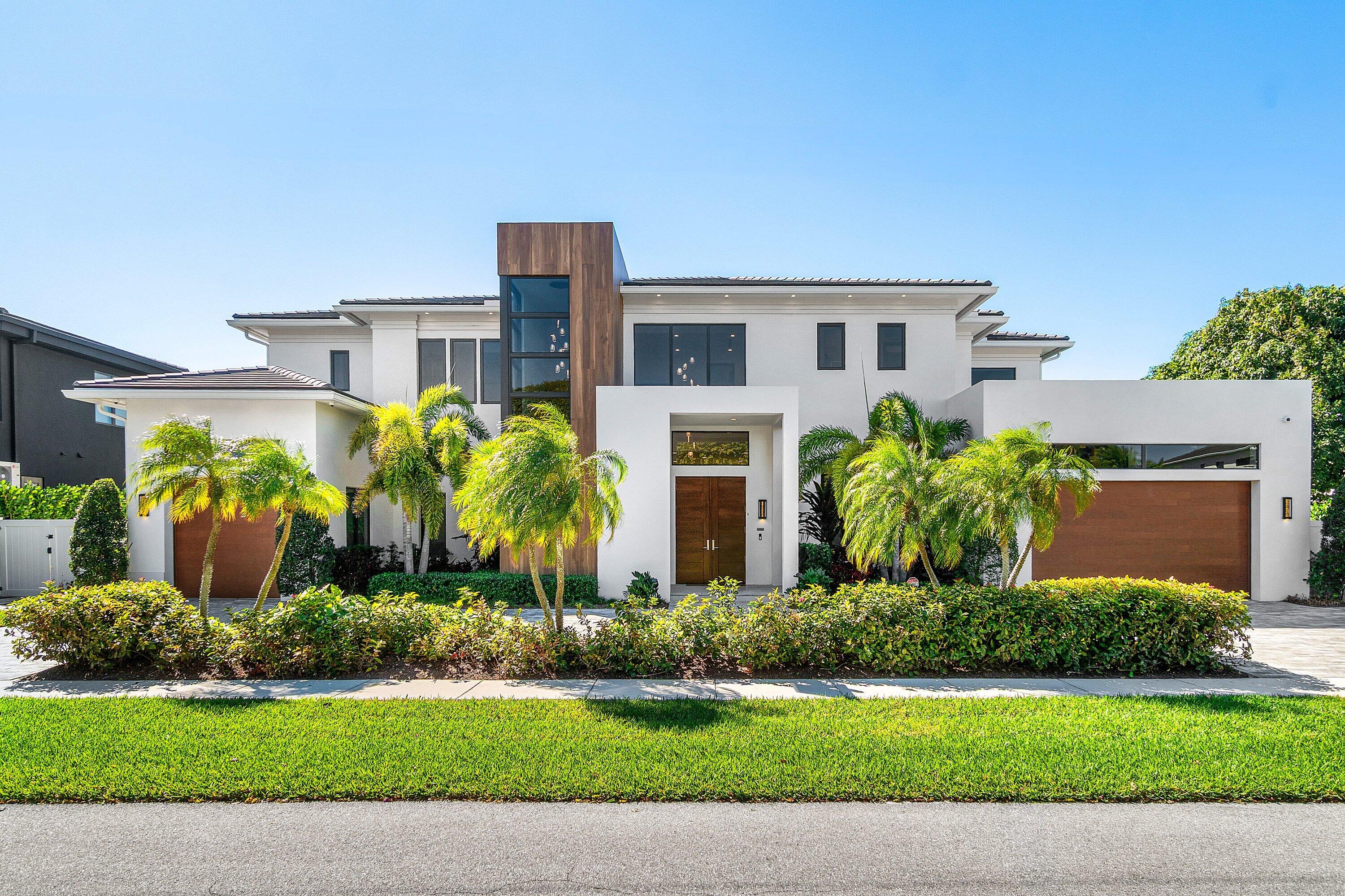 450 Northeast 10th Street Boca Raton, FL 33432 - Photo 60 of 119 a front view of a house with a yard and potted plants