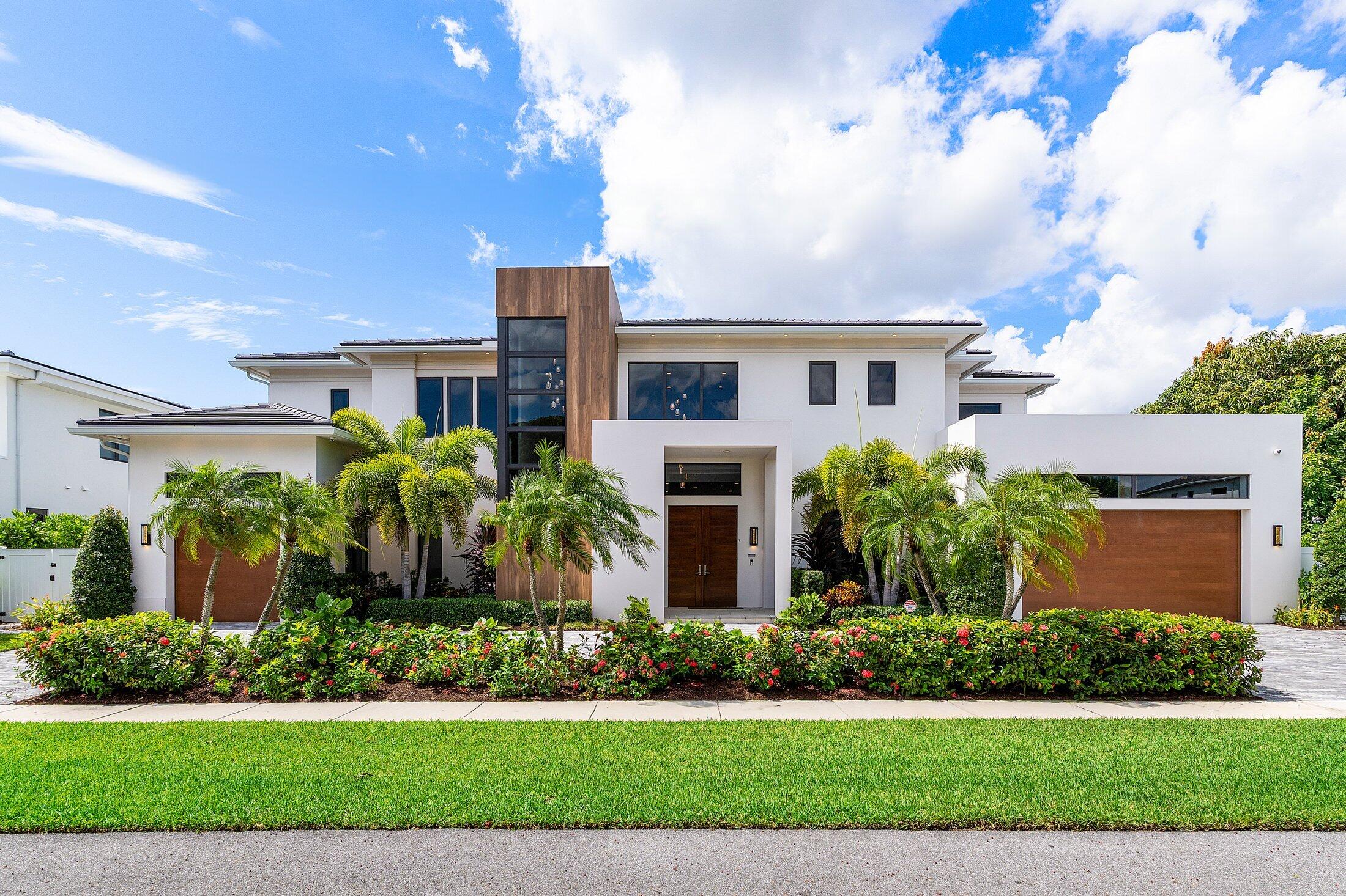 450 Northeast 10th Street Boca Raton, FL 33432 - Photo 6 of 119 a front view of a house with a yard and potted plants