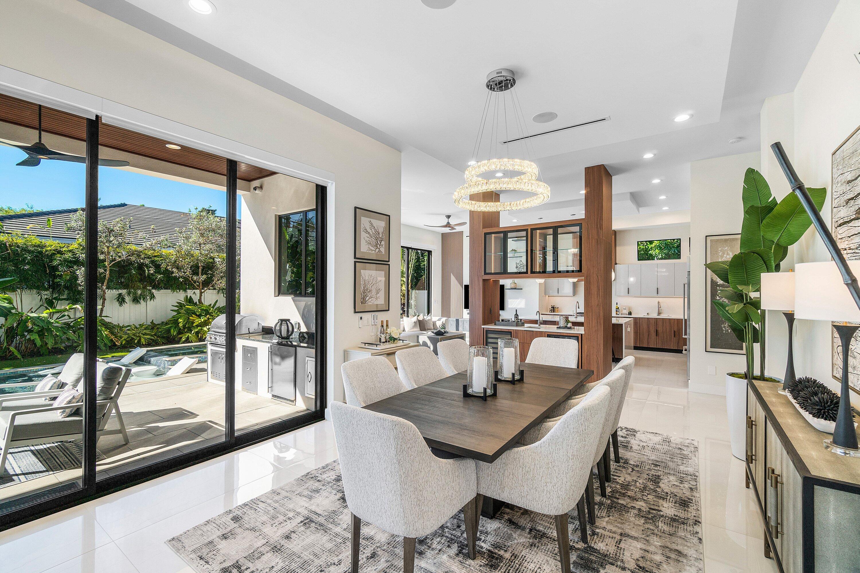450 Northeast 10th Street Boca Raton, FL 33432 - Photo 69 of 119 a dining room with furniture a chandelier and wooden floor
