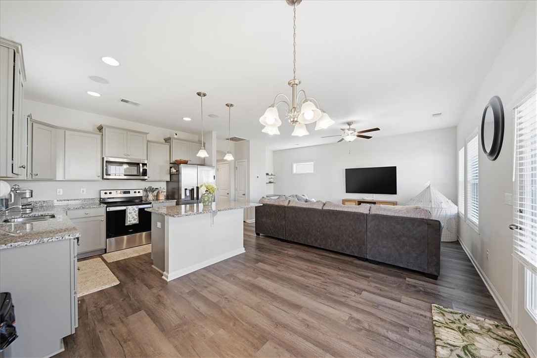 403 Seaborn Circle Pendleton, SC 29670 - Photo 17 of 47 An open-concept living area with a well-equipped kitchen and a comfortable lounging space features durable flooring.