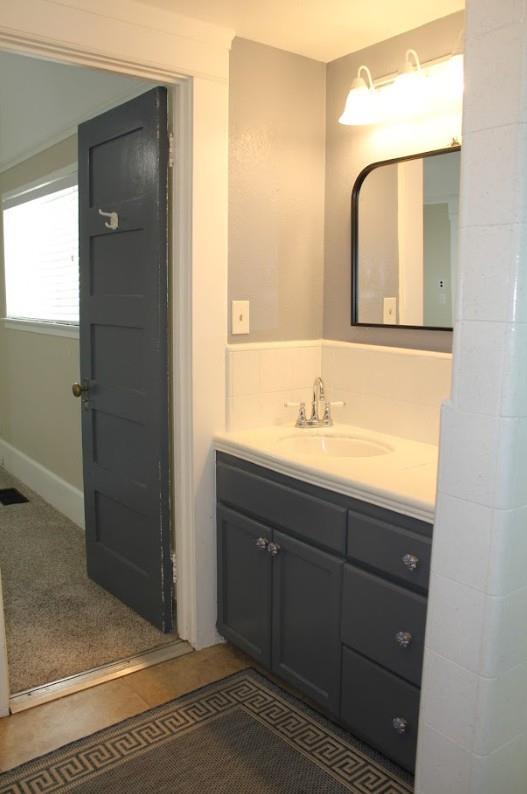 331 North 6th Street Fowler, CA 93625 - Photo 18 of 31 a bathroom with a sink a mirror and a shower