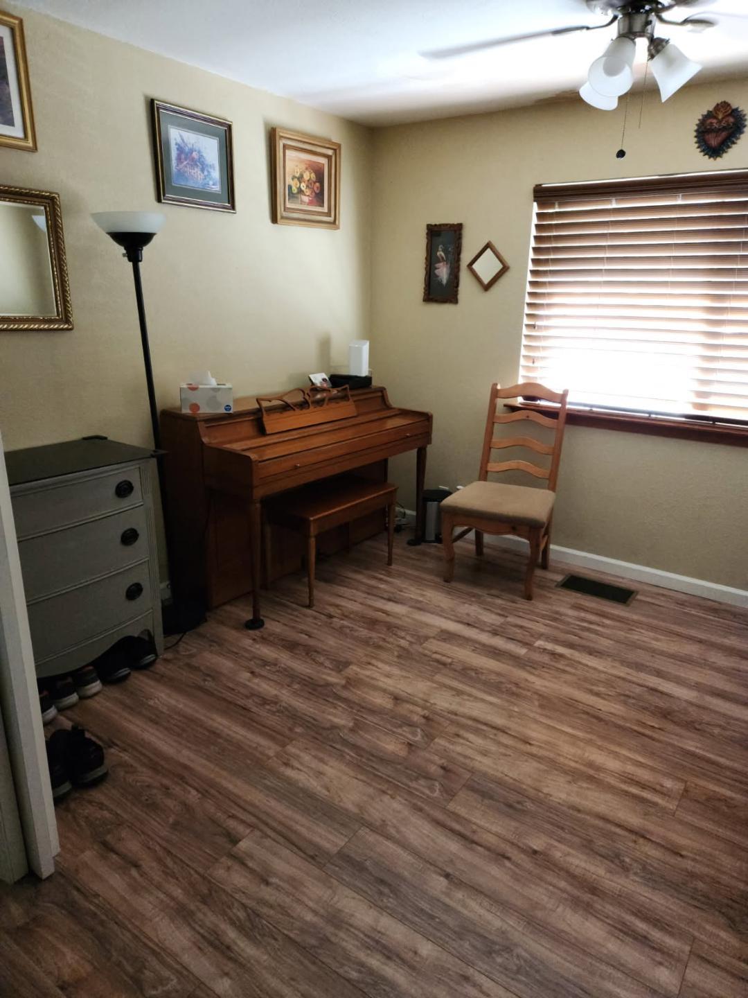 331 North 6th Street Fowler, CA 93625 - Photo 28 of 31 a room with wooden floor and furniture
