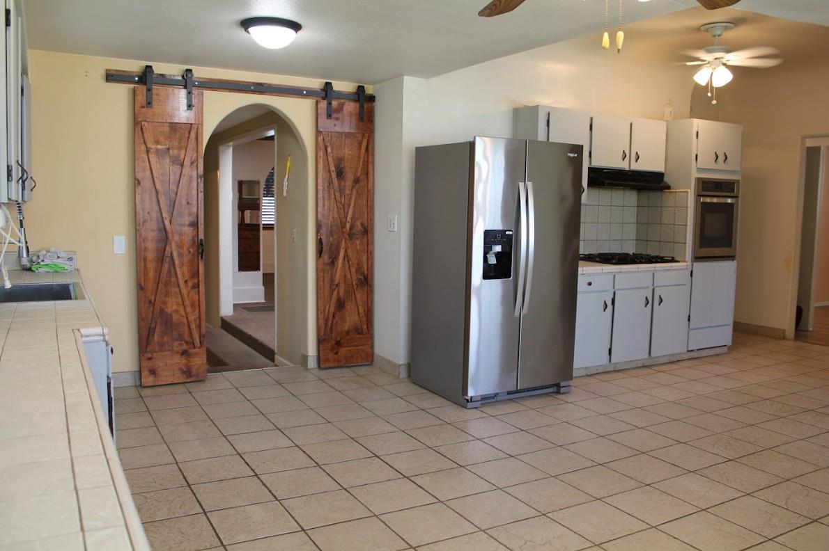 331 North 6th Street Fowler, CA 93625 - Photo 6 of 31 a view of a refrigerator and window in a kitchen