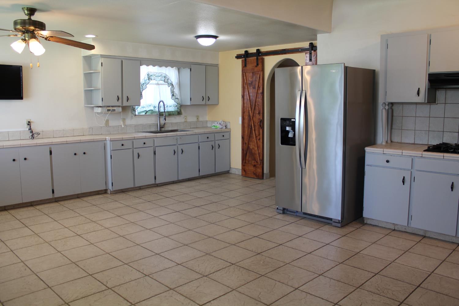 331 North 6th Street Fowler, CA 93625 - Photo 8 of 31 a kitchen with a refrigerator and a sink