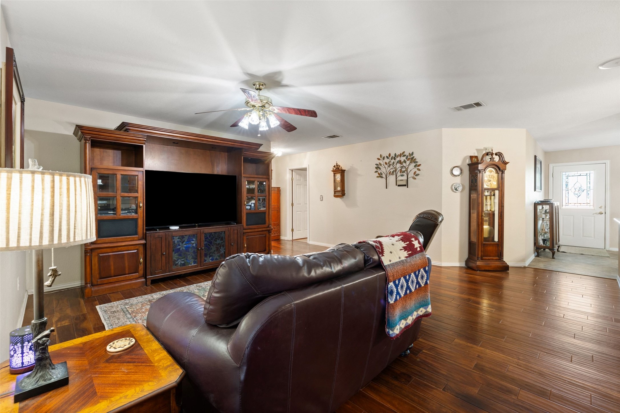 399 Upper Elgin River Road Elgin, TX 78621 - Photo 22 of 39 Living area with dark wood flooring and a ceiling fan