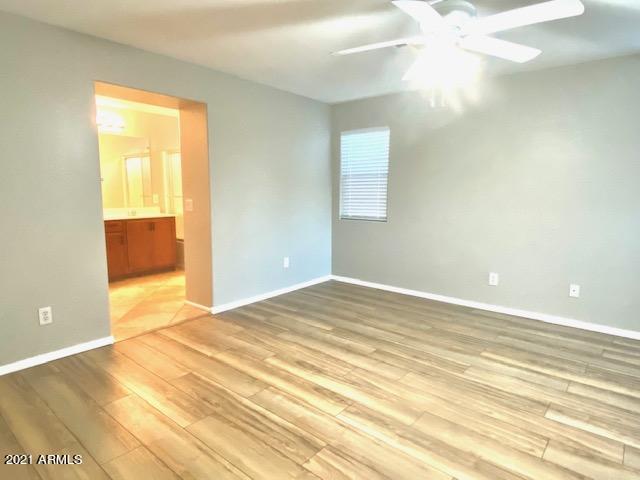 3657 East Hyatt Lane Gilbert, AZ 85295 - Photo 6 of 8 a view of an empty room with wooden floor and a window