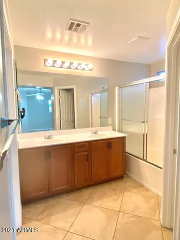 a bathroom with a sink a mirror and a bathtub