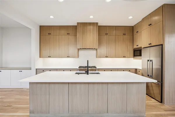 a kitchen with refrigerator a sink and cabinets