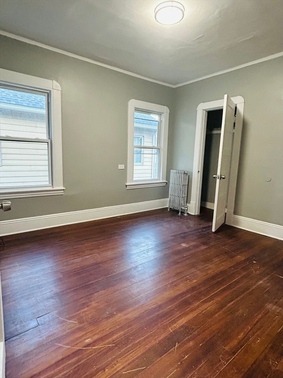 44 Virginia Street, Unit 1 Springfield, MA 01108 - Photo 12 of 13 an empty room with wooden floor and windows