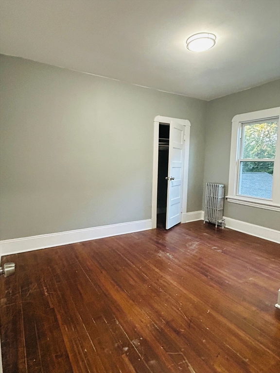 44 Virginia Street, Unit 1 Springfield, MA 01108 - Photo 13 of 13 an empty room with wooden floor and windows