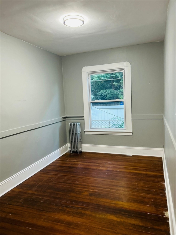44 Virginia Street, Unit 1 Springfield, MA 01108 - Photo 7 of 13 an empty room with wooden floor and windows