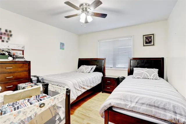 a bedroom with two beds and a chandelier