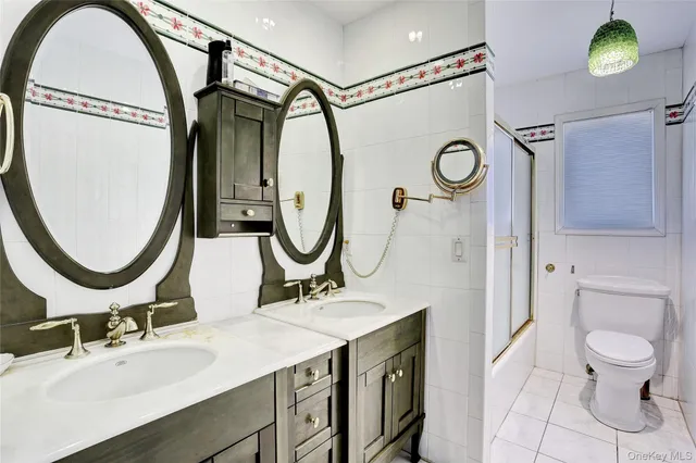a bathroom with a sink vanity mirror and toilet