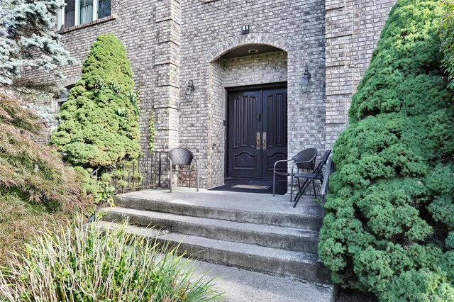 a front view of a house with a garden