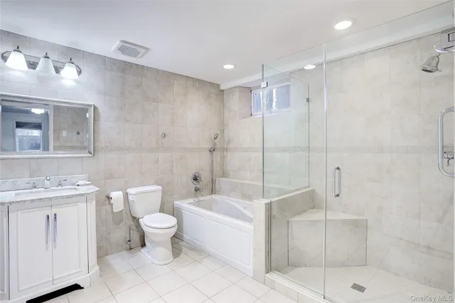 a bathroom with a toilet sink and shower