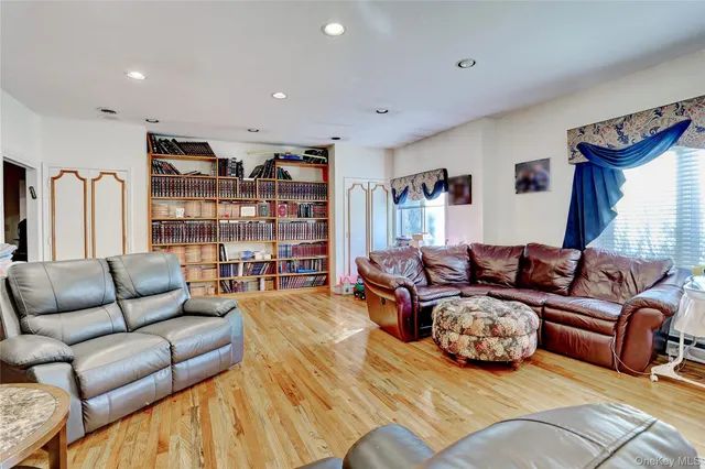 a living room with furniture a rug and a book shelf