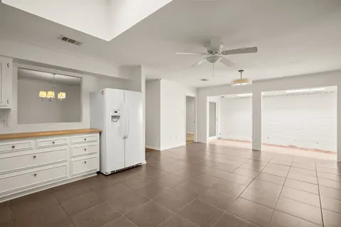 a view of an empty room with cabinet and cabinet