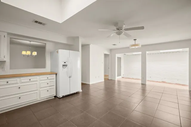 a view of an empty room with cabinet and cabinet