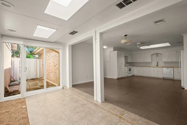 a view of a kitchen with a sink and a window