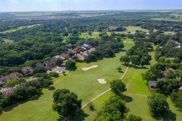 an aerial view of a houses with a yard