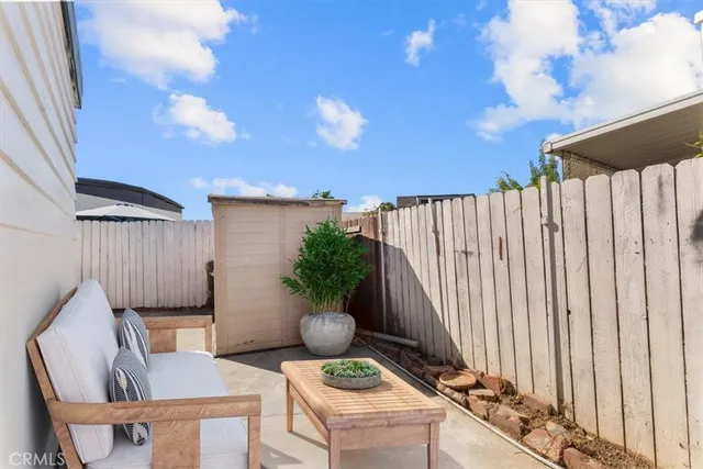 a backyard of a house with table and chairs