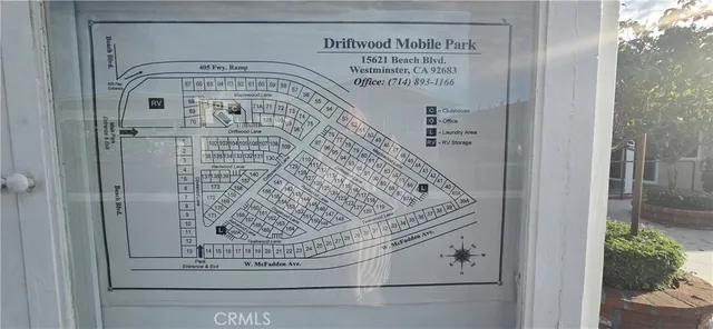 a view of a house with a big yard and large trees