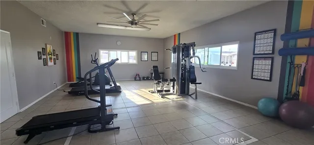 a room with gym equipment and windows