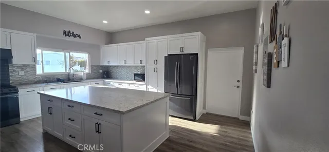 a dining room with lots of furniture wooden floor and a chandelier