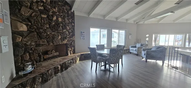 a living room with furniture a fireplace and a ceiling fan